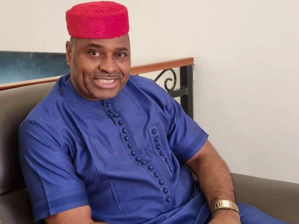 Kenneth Okonkwo in a red cap.