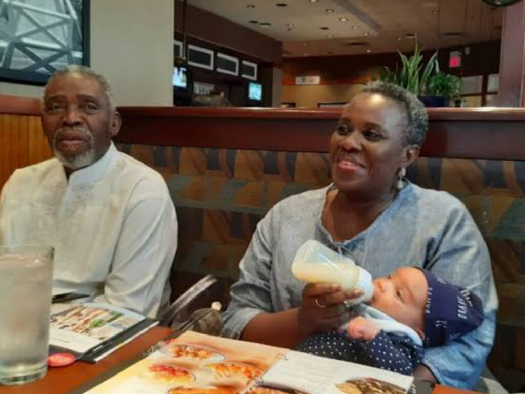 Olu Jacobs and Joke Silva with their granchild. Joke Silva feeding the child.